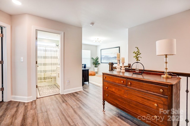 interior space with wood finished floors and baseboards