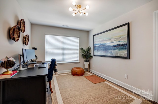 office space featuring an inviting chandelier, baseboards, and visible vents