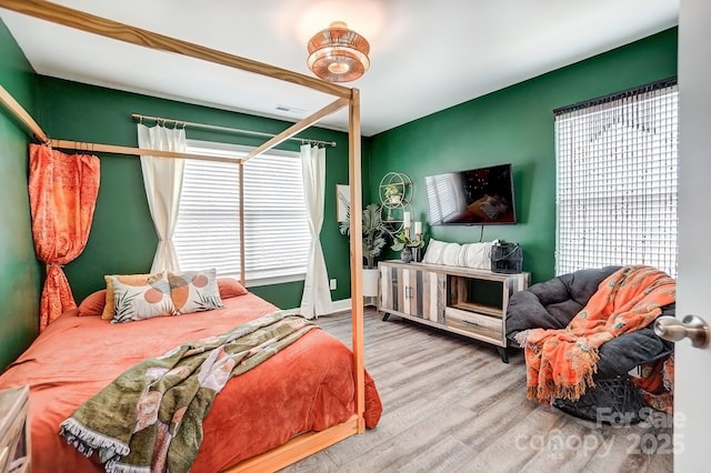 bedroom with wood finished floors and visible vents