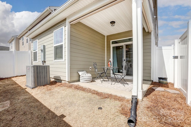 view of patio / terrace with central AC unit and fence