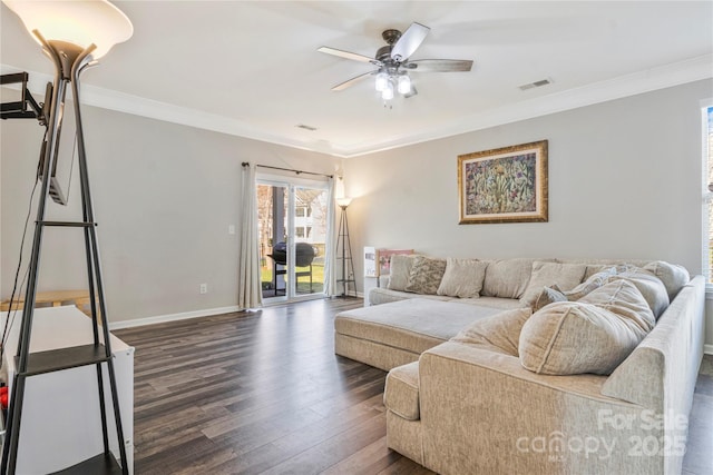 living area featuring crown molding, visible vents, dark wood-type flooring, ceiling fan, and baseboards