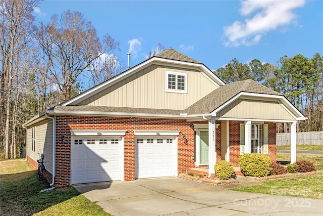 view of front facade with a shingled roof, brick siding, and driveway