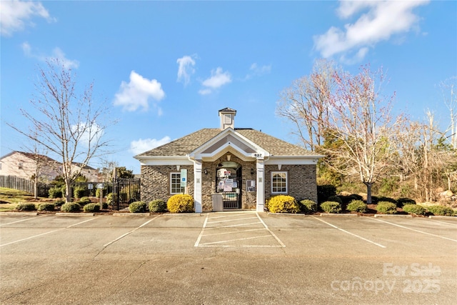 view of property featuring uncovered parking and fence