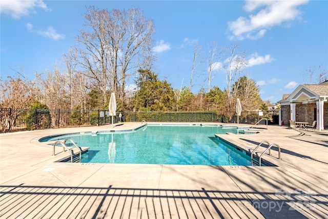 pool featuring a patio area and fence