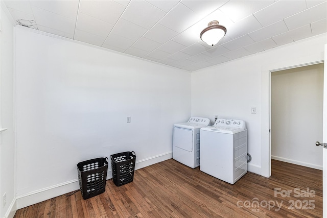 laundry room featuring washer and clothes dryer, laundry area, baseboards, and wood finished floors