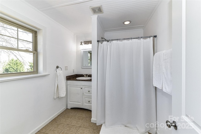 bathroom featuring tile patterned flooring, visible vents, crown molding, baseboards, and vanity