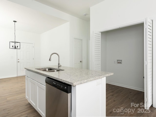 kitchen featuring wood finished floors, a sink, white cabinetry, light stone countertops, and dishwasher