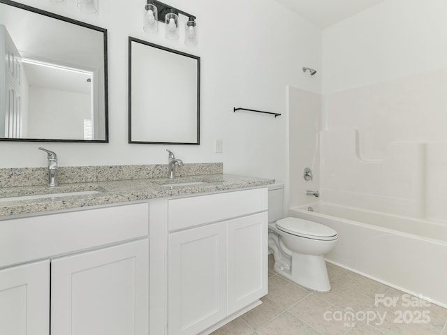 full bathroom with double vanity, toilet, tile patterned flooring, bathtub / shower combination, and a sink