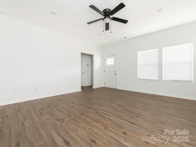 unfurnished living room featuring wood finished floors, a ceiling fan, and baseboards