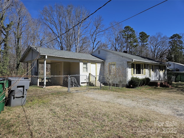 exterior space with a lawn, fence, and a gate