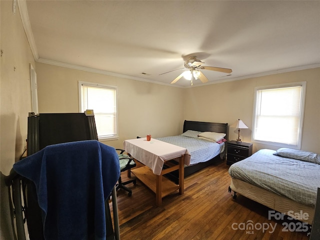 bedroom featuring ceiling fan, ornamental molding, multiple windows, and wood-type flooring