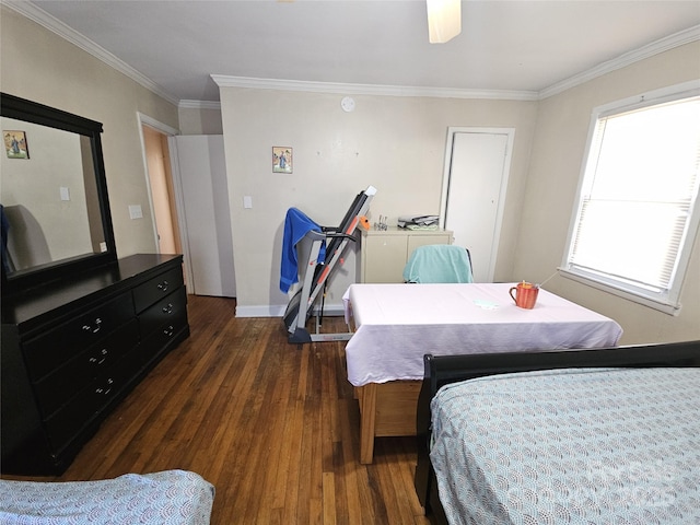 bedroom with dark wood-style floors, ornamental molding, and baseboards