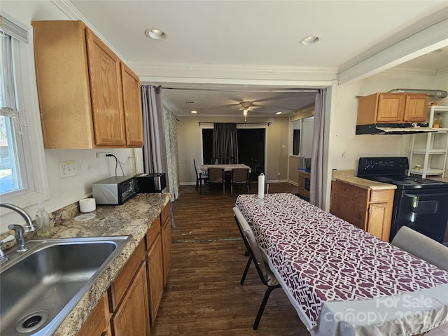 kitchen with black range with electric cooktop, dark wood-style flooring, a sink, ventilation hood, and brown cabinetry