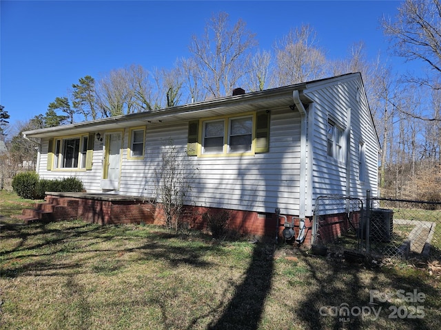 view of front of house with crawl space, fence, central AC, and a front yard