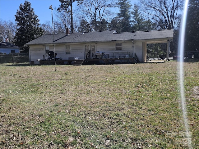 back of property featuring a yard