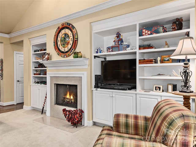 living area with built in features, light colored carpet, a fireplace with flush hearth, vaulted ceiling, and baseboards