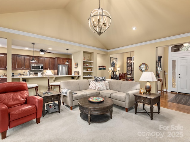 living room with built in shelves, high vaulted ceiling, recessed lighting, wood finished floors, and a chandelier