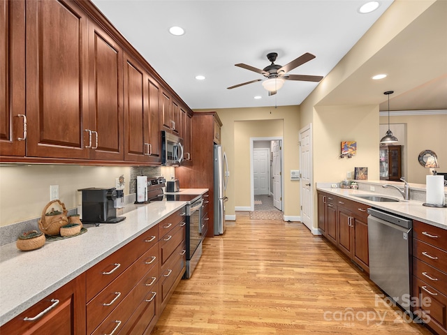 kitchen featuring stainless steel appliances, recessed lighting, a sink, ceiling fan, and light wood-type flooring