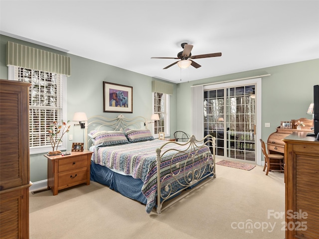 carpeted bedroom featuring a ceiling fan, access to outside, and baseboards