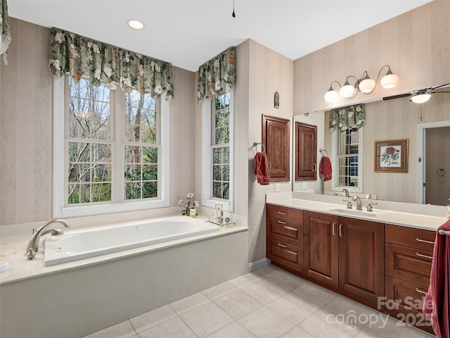 bathroom featuring a bath, tile patterned flooring, vanity, and a ceiling fan