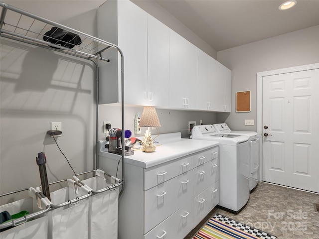 clothes washing area featuring recessed lighting, cabinet space, and washer and dryer