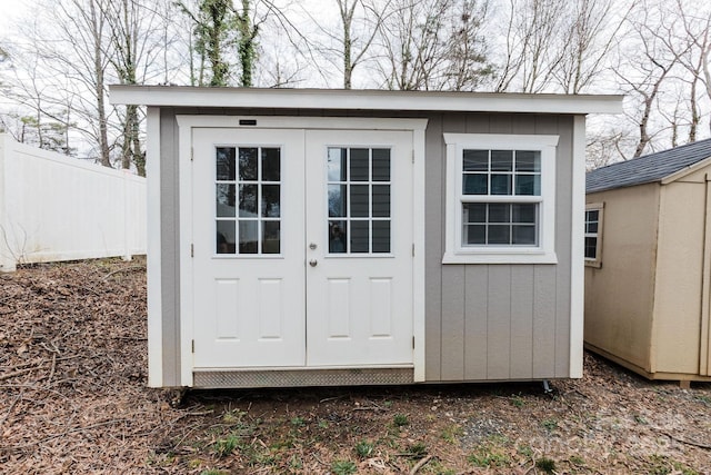 view of shed featuring fence