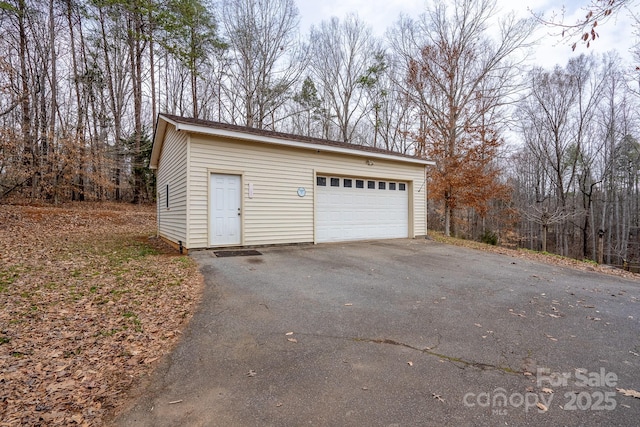 garage featuring aphalt driveway