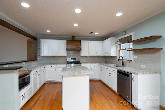 kitchen with premium range hood, open shelves, a sink, appliances with stainless steel finishes, and light wood finished floors