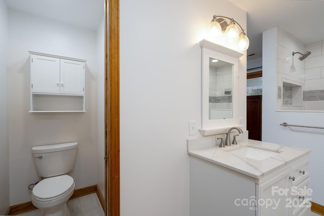 full bath featuring baseboards, toilet, and vanity