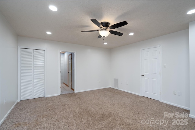 unfurnished bedroom with carpet flooring, recessed lighting, visible vents, and baseboards