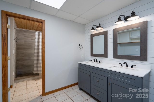 bathroom featuring tile patterned floors, double vanity, and a sink