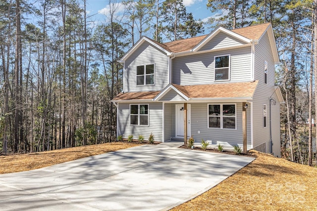 traditional home with roof with shingles