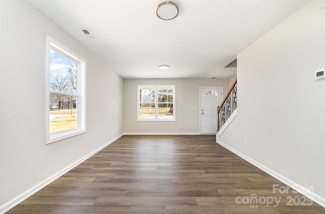 entryway with dark wood-style flooring, visible vents, stairway, and baseboards