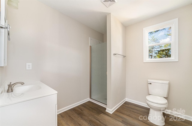 full bathroom with a stall shower, visible vents, toilet, and wood finished floors