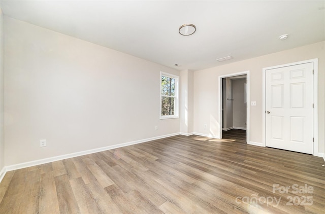 2206 Hillcrest Ave, Albemarle, NC 28001 - unfurnished bedroom with wood finished floors and a walk in closet