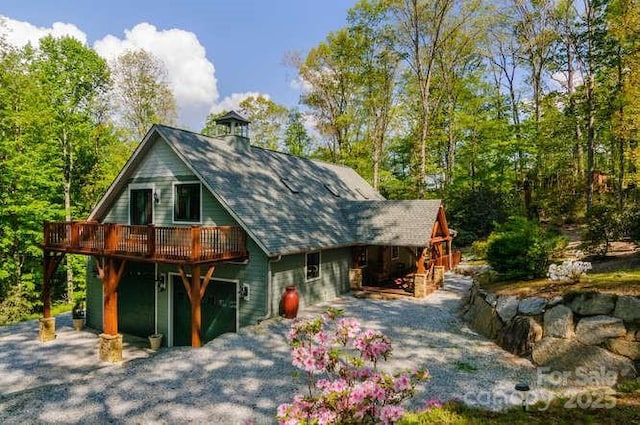 view of front of home with a wooden deck and a chimney