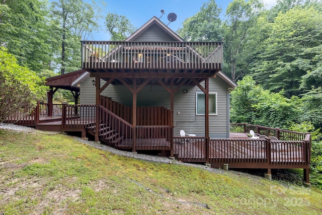 back of house with a wooden deck and a yard