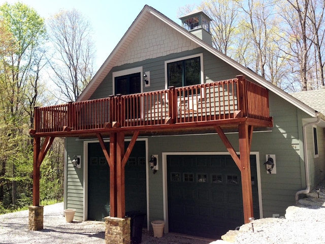 view of front of home with a deck and an attached garage