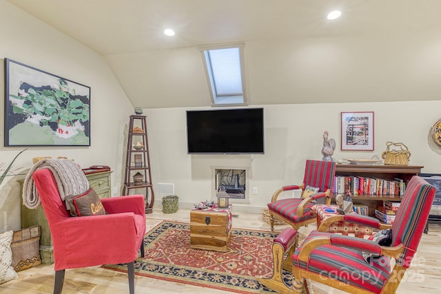 living room with lofted ceiling, recessed lighting, and wood finished floors