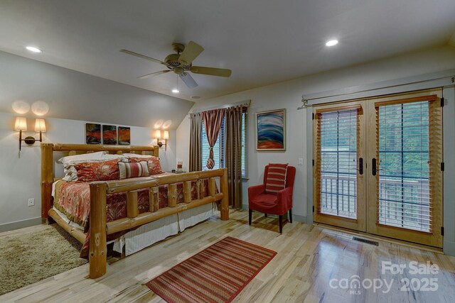 bedroom with access to outside, wood finished floors, multiple windows, baseboards, and recessed lighting