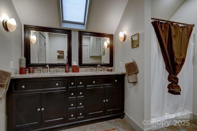 bathroom featuring baseboards, double vanity, a shower with curtain, and vaulted ceiling