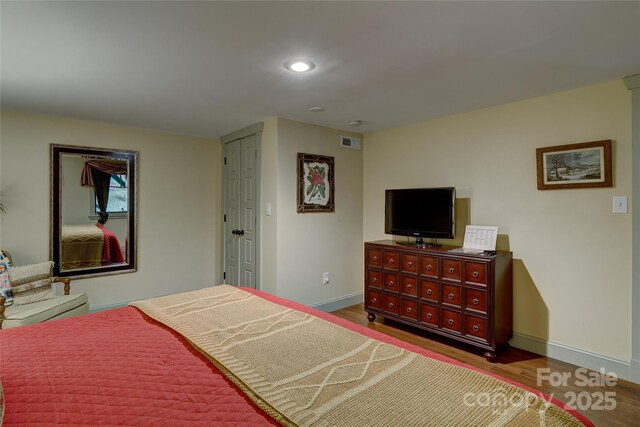 bedroom with wood finished floors, baseboards, and recessed lighting