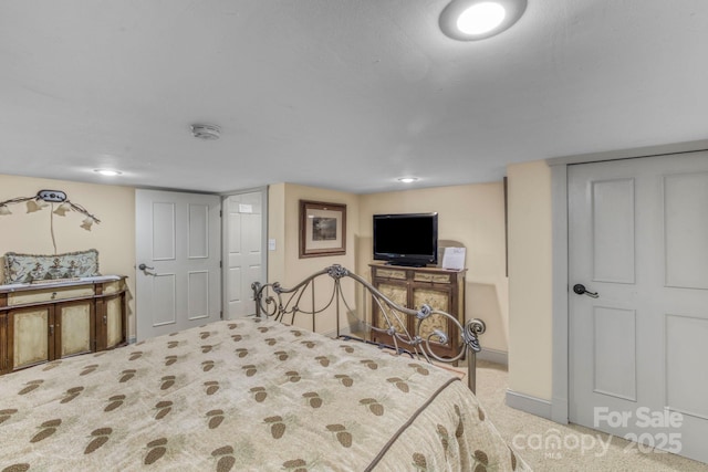 carpeted bedroom featuring baseboards