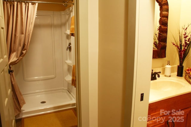 bathroom with a shower with curtain and vanity