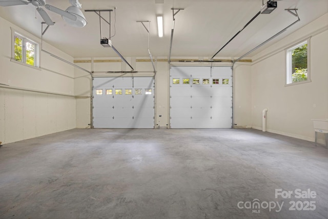 garage with a garage door opener and ceiling fan