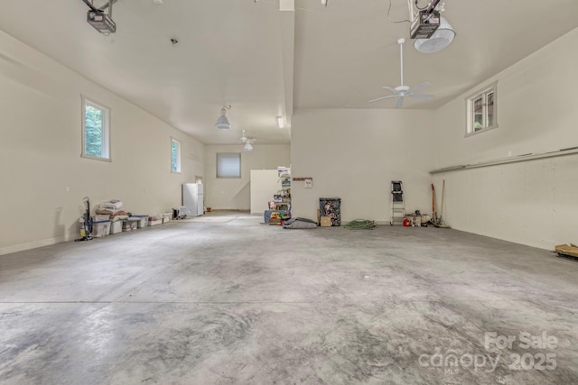 garage featuring ceiling fan and a garage door opener