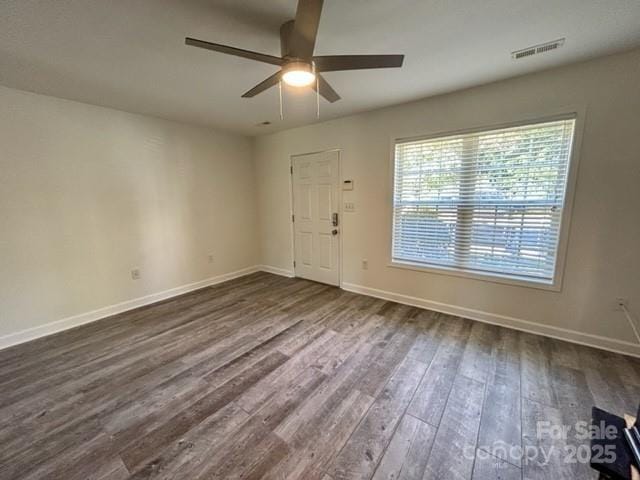 entrance foyer featuring dark wood-style flooring, visible vents, ceiling fan, and baseboards