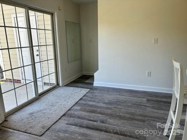 empty room featuring wood finished floors and baseboards