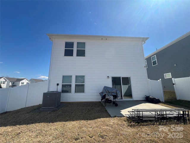 back of property featuring a patio, a lawn, central AC, and fence