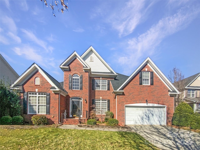 view of front of property with a garage, a front yard, concrete driveway, and brick siding